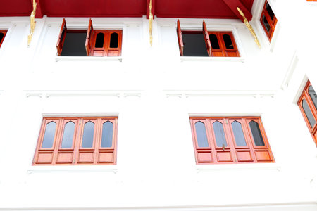 Red brown wood windows and white wall, retro style windows in rectangle shape, Thailand.の写真素材