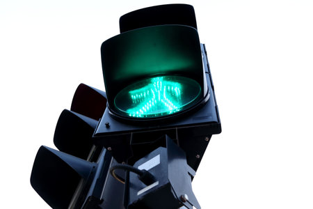 Green light man symbol sign for pedestrian cross road on trafiic light at junction in Bangkok and white sky background, Thailand.の写真素材