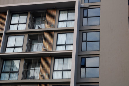 Close up outside of building detail balcony view decorate glass and curtain of room in Thailand.