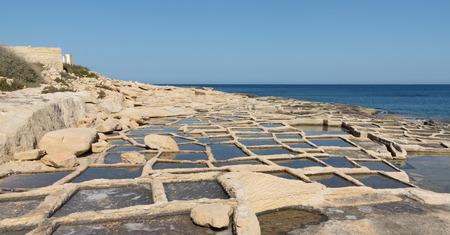 Historic salt pans filled with seawater, Marsaskala, Maltaの写真素材