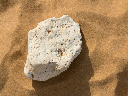 Single stone on a sandy beachの写真素材