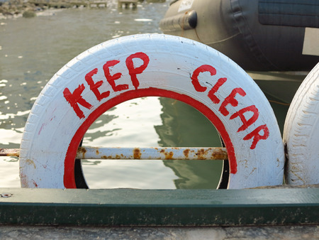  Keep clear , written on an old, white coloured car tyreの写真素材