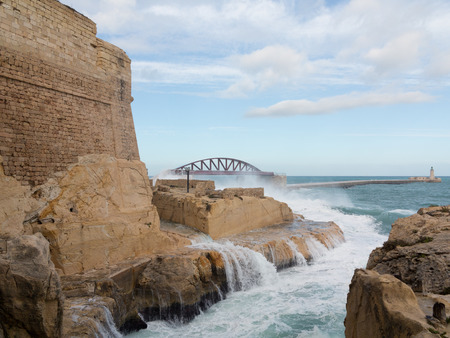 Port entrance of the Grand Harbour of Valletta on a stormy dayの写真素材