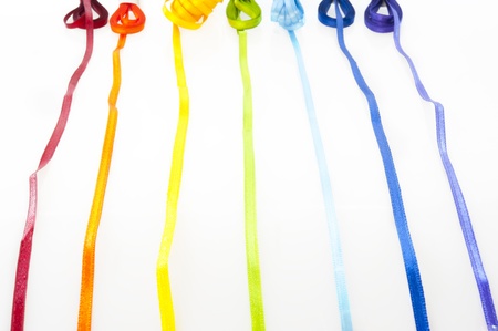 Satin ribbons of all colors on a white backgroundの写真素材