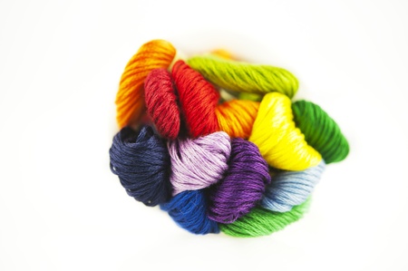 Embroidery threads of every color of the rainbow on a white backgroundの写真素材