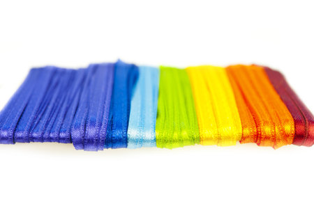 Satin ribbons of all colors on a white background