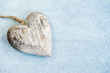 one wooden heart on the background of the wooden tableの写真素材