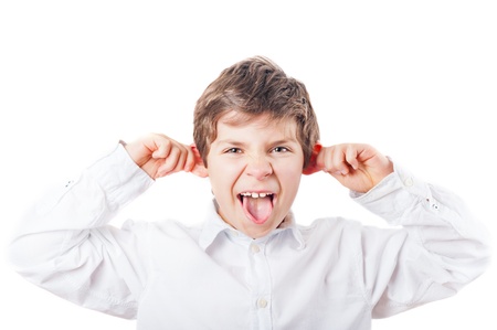 grimacing European boy from the front in the white shirt on a white backgroundの写真素材