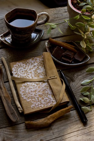 Morning coffee and favorite leather notebook for recordsの写真素材