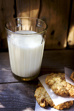 Glass of milk and some sweet cookiesの写真素材