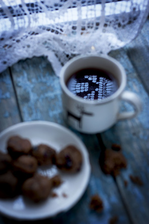 Reflection vintage lace napkins on the surface of the coffee in the cupの写真素材