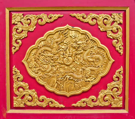 golden dragon decorated on red woodの写真素材