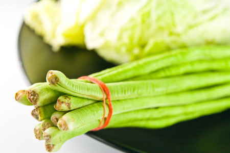Green beans on black dishの写真素材