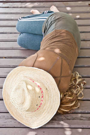 Woman in hat relaxing on holidayの写真素材