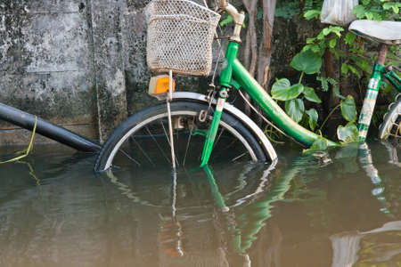 BANGKOK THAILAND - SEP 13:The water level up to 60-70 cm, making it impossible to use a bicycle in traffic. Flood event on Septemper 13,2011 Soi Raminthra 109, Bangkok Thailand のeditorial素材