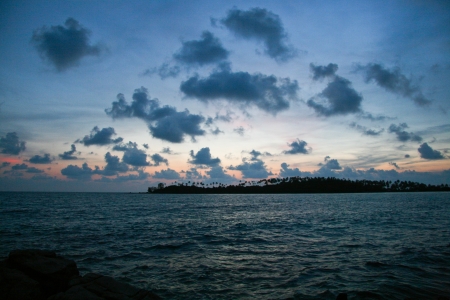 Silhouette of an island with the clouds in the skyの写真素材