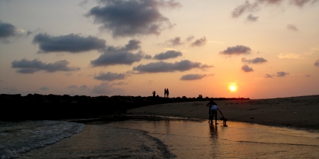 Peoples have a relax at the beach in the sunsetの写真素材