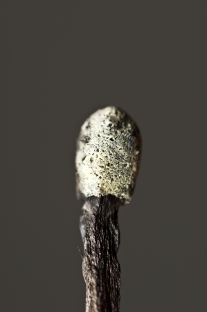 Burned match on dark background の写真素材