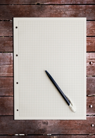 sheet of paper on wood background の写真素材