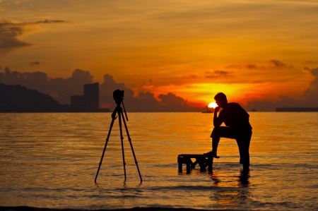 a silhouette of  photographer shooting for a sunriseの写真素材