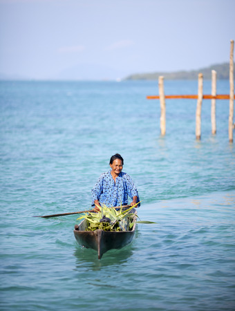 MABUL ISLAND, SABAH, MALAYSIA - MARCH 03 : Unidentified Sea Gypsies paddles a boat on March 03, 2014 in Sabah, Malaysia. The Sea Gypsies are sea nomads that move from one place to another.のeditorial素材