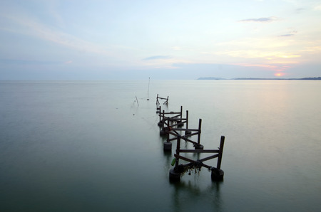 broken fisherman jetty during sunsetの写真素材