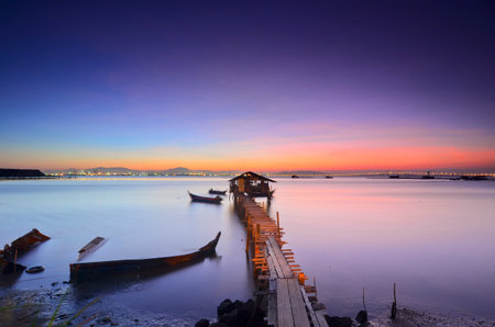 fisherman's cottage and pier at sunrise.の写真素材