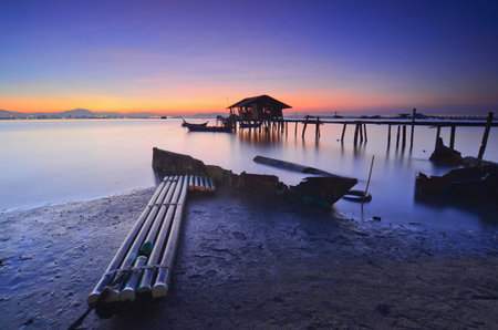 fisherman's cottage and pier at sunrise.の写真素材