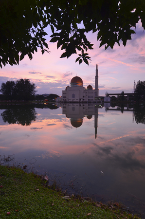 a panoramic view of floating public mosque during awesome sunsetの写真素材