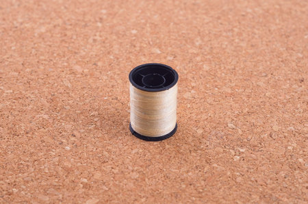 still life of spools of thread on a wooden background.