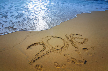 2016 written on a sandy beach, concept for new year greeting cards and calendars