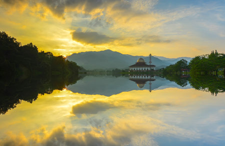 Majestic view of Darul Quran Mosque during sunset with mirror reflection in the lake. Soft focus due to long exposure. Virant colours.の写真素材
