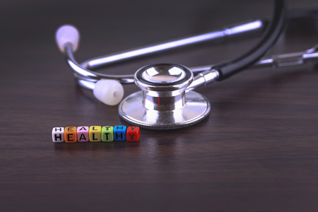 Healthy word with stethosope on wood table.の写真素材