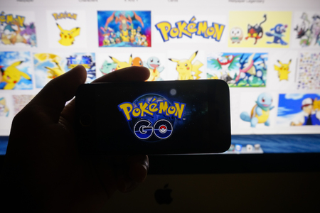 KUALA LUMPUR, MALAYSIA - JULY 15TH, 2016 : A silhouette of man try to install POKEMON GO games, a free-to-play augmented reality mobile game developed by Niantic for iOS and Android devices.のeditorial素材