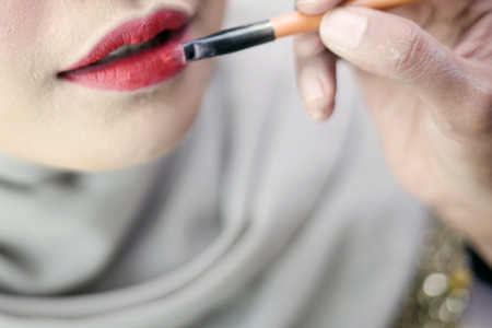 Close up portrait of attractive girl rouging her lips.の写真素材