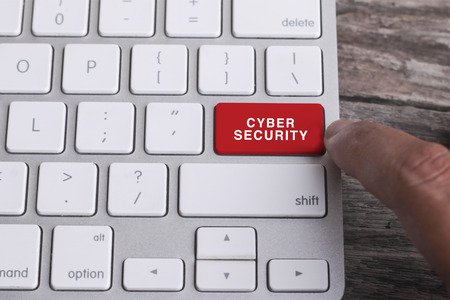 Close up of finger on keyboard button with CYBER SECURITY wordの写真素材