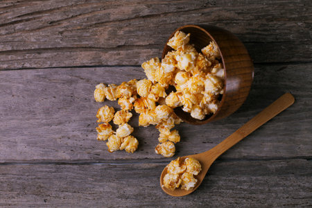 Caramel popcorn in the bowl wooden backgroundの写真素材
