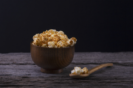 Caramel popcorn in the bowl wooden backgroundの写真素材