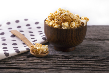 Caramel popcorn in the bowl wooden white background.の写真素材