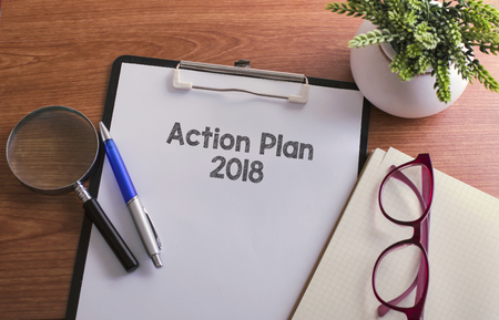 Action Plan word on paper with glass ballpen and green plantの写真素材