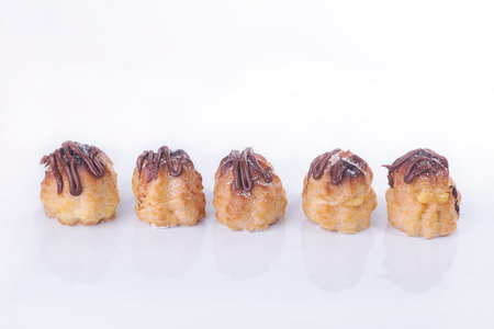 Chocolate cream puff isolated on white background