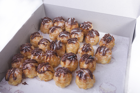 Chocolate cream puff isolated on white backgroundの写真素材