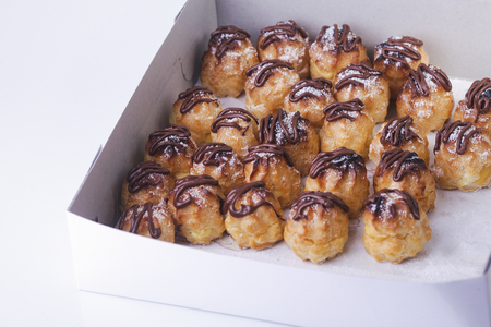 Chocolate cream puff isolated on white backgroundの写真素材
