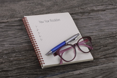 Top view of notebook written New Year Resolution on wooden backgroundの写真素材