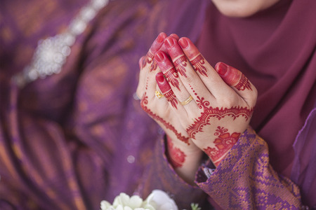 Henna and wedding ring on bride hand, pray for doa sessionの写真素材