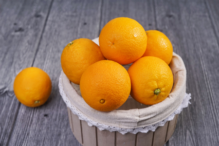 Basket of oranges on wooden backgroundの写真素材
