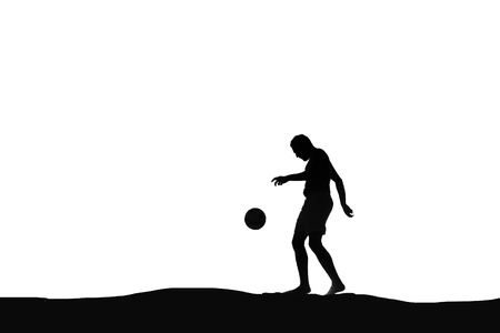 Silhouette of a man playing footballの写真素材