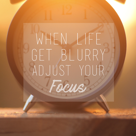Inspirational quote "When life gets blurry adjust your focus" on alarm clock background.happiness conceptの写真素材