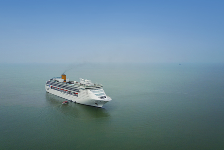 White luxury cruise ship docked in beautiful Caribbean sea close to the beachの写真素材