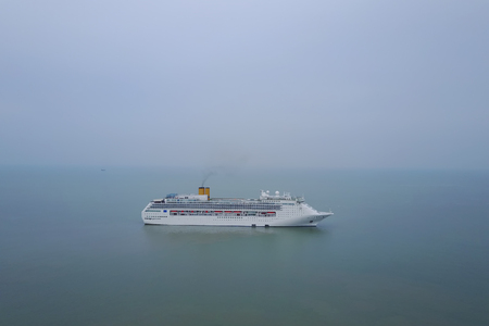 White luxury cruise ship docked in beautiful Caribbean sea close to the beachの写真素材